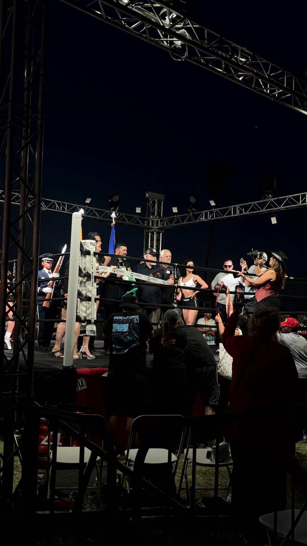 Wrestlers pose inside a ring